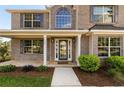 Inviting front porch featuring a detailed front door and lush landscaping, enhancing curb appeal at 191 Kyndal Dr, Hampton, GA 30228