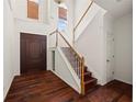 Bright foyer with hardwood floors, a staircase, and a view of the front door at 2890 Winterhaven Ct, Atlanta, GA 30360