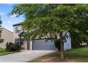 Exterior view of home with garage at 468 Lake Ridge Ln, Fairburn, GA 30213