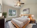 Serene main bedroom with vaulted ceilings, a ceiling fan, a neutral color palette, and natural light at 6001 Deer Springs Nw Ln, Acworth, GA 30101