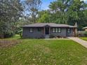 Charming single-story home featuring a well-manicured lawn and freshly painted exterior at 1643 Flintwood Se Dr, Atlanta, GA 30316