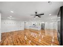 Spacious living room with hardwood floors, open to the kitchen, and featuring a modern fireplace at 2798 Hutchins Rd, Lawrenceville, GA 30044