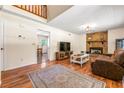 Comfortable living room featuring hardwood floors, stone fireplace, and a large window with natural light at 4150 Kalb Sw Ct, Smyrna, GA 30082