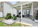 Inviting front porch with seating area, decorative landscaping, and a clear view of the home's address at 5322 Burrus Sw Ln, Mableton, GA 30126