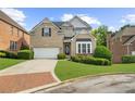 Charming two-story brick home with well-manicured lawn and a brick-lined driveway at 2321 Norbury Se Cv, Smyrna, GA 30080
