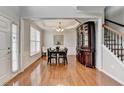 Dining room featuring hardwood floors, tray ceiling, natural light and decorative china cabinet at 475 Bayswater Way, Suwanee, GA 30024