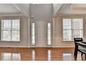 Bright foyer with gleaming hardwood floors, large windows, and a soaring ceiling at 475 Bayswater Way, Suwanee, GA 30024