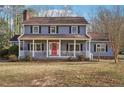 Inviting two-story home showcasing a classic front porch and well-maintained landscaping at 130 Thornton Dr, Fayetteville, GA 30214