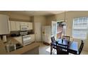 Bright kitchen with white cabinets, dining area, and access to a deck at 3263 Mill Springs Circle Northeast Cir, Buford, GA 30519
