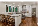 Stylish kitchen with island seating, stainless steel appliances, custom cabinetry, and hardwood floors at 3275 Lord N Lady Ln, Alpharetta, GA 30022