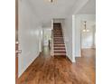 Inviting foyer with hardwood floors and staircase leading to upper level and dining room at 4515 Ambassador Way, Cumming, GA 30040