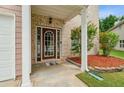 Welcoming front porch with brick facade, manicured landscaping, and a charming entryway at 4515 Ambassador Way, Cumming, GA 30040