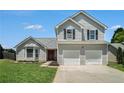 Two story home with red door, bay window, and a two car garage at 4578 Score Ct, Snellville, GA 30039