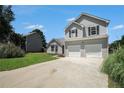 A lovely two-story home has a two-car garage and large driveway with mature trees at 4578 Score Ct, Snellville, GA 30039