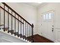 Inviting entryway with hardwood floors, classic wainscoting, and a staircase with dark wood handrail at 178 Munira Sw Ln, Atlanta, GA 30331