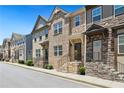 Charming townhome exteriors with stone accents, inviting front porches, and well-maintained landscaping at 178 Munira Sw Ln, Atlanta, GA 30331