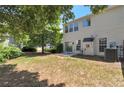 A view of the back exterior and yard from a slightly different angle, showing lawn and AC unit at 2907 Timbercreek Cir, Roswell, GA 30076