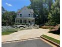 Beautifully designed home with a well-manicured lawn, charming white picket fence, and spacious driveway at 3240 Columbia Oaks Way, Decatur, GA 30032
