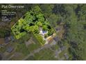Aerial view of a home on a lush 1.04-acre lot in a wooded area at 6235 Akins Way, Cumming, GA 30041