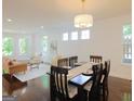 Open-concept dining and living area with hardwood floors and lots of natural light at 1454 Rome Nw Dr, Atlanta, GA 30314