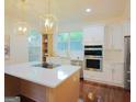 Bright, modern kitchen with stainless steel appliances, white cabinets, and a center island at 1454 Rome Nw Dr, Atlanta, GA 30314