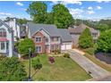 Charming home with a manicured lawn, a two-car garage, and a mix of brick and siding exterior at 2325 Walnut Grove Way, Suwanee, GA 30024