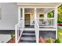 Inviting front porch with stylish decor and a welcoming entrance with number 2876 at 2876 Randall St, East Point, GA 30344