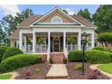 Inviting front porch adorned with hanging plants and a beautiful doorway, offering a warm welcome at 3902 Butterstream Way, Kennesaw, GA 30144