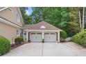 Spacious two-car garage featuring white doors and stylish architecture, with a convenient side entrance at 3902 Butterstream Way, Kennesaw, GA 30144
