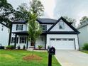 Beautiful two-story home featuring a manicured lawn and a convenient two-car garage at 1540 Ox Bridge Ct, Lawrenceville, GA 30043