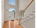 Sunlit entryway with high ceilings, wood floors, and a staircase at 1712 Bonnabel Ne Trce, Marietta, GA 30066