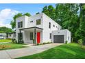 Contemporary home boasts a two-car garage, green lawn, and modern design at 2926 5Th Sw St, Atlanta, GA 30315
