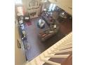 Overhead view of the living room with a fireplace, L-shaped couch, and neutral-toned carpet at 7625 Cedar Grove Ct, Fairburn, GA 30213