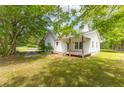 Exterior showcasing a classic covered porch, a well-maintained lawn and driveway at 1730 Lee Peters Rd, Loganville, GA 30052