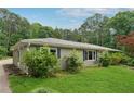 A charming home featuring a well-manicured lawn and mature trees surrounding the property at 1926 Parkwood Rd, Snellville, GA 30078