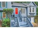Inviting front porch with a red door and stylish railings on a blue home at 2715 Braemore Gln, Powder Springs, GA 30127