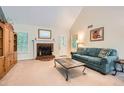 Bright living room with a fireplace, plush carpeting, and comfortable seating at 2715 Braemore Gln, Powder Springs, GA 30127