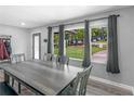 Inviting dining area showcasing large windows, modern flooring and a gray dining set at 2903 Monterey Dr, Decatur, GA 30032