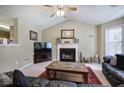 Cozy living room features a fireplace and seamlessly connects to the dining area and kitchen at 1047 Taso Trl, Acworth, GA 30101