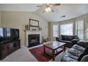 Spacious living room with a fireplace, large windows and comfortable seating area at 1047 Taso Trl, Acworth, GA 30101