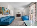 Open living room featuring stylish blue sofas, wood-look flooring, a piano, and ample natural light at 1312 Brandl Dr, Marietta, GA 30008