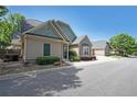 Well-maintained home featuring neutral siding, manicured landscaping, and an attached two-car garage at 223 Glens Loop, Woodstock, GA 30188