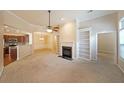 Bright living room featuring a fireplace, built-in shelves, and an open floor plan with views to kitchen and dining at 223 Glens Loop, Woodstock, GA 30188