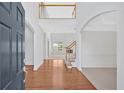 Bright foyer with gleaming hardwood floors, soaring ceilings, and an open staircase create an inviting entrance at 2372 Oberon Se Walk, Smyrna, GA 30080