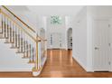 Inviting foyer with hardwood floors and staircase, leading to the upper levels of the home at 2372 Oberon Se Walk, Smyrna, GA 30080