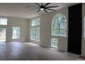 Spacious living room with light wood floors, lots of light, and stylish black fireplace at 4220 Glad Morning Dr, College Park, GA 30349