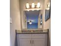 Bathroom with a vanity, granite countertop, a large mirror, and modern lighting fixtures at 5389 Martins Crossing Rd, Stone Mountain, GA 30088