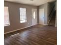 Inviting living room featuring new flooring, natural light, and access to the staircase at 5389 Martins Crossing Rd, Stone Mountain, GA 30088