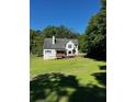 Large backyard with mature trees and a spacious lawn, perfect for outdoor activities and relaxation at 410 Hendon Rd, Woodstock, GA 30188