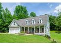 Lovely home with a welcoming front porch and a well-maintained lawn, plus a convenient two-car garage at 410 Hendon Rd, Woodstock, GA 30188
